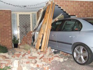 Car ploughs into home