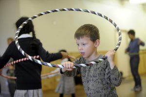 Kids through hula hoop paces